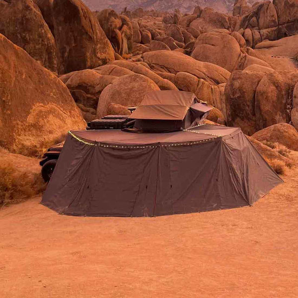 OVS HD Nomadic 270 Awning 3-Piece Wall Kit — Lifestyle shot: enclosed 270 awning at a red-rock desert camp. A full weather room off the side of a truck for long stays