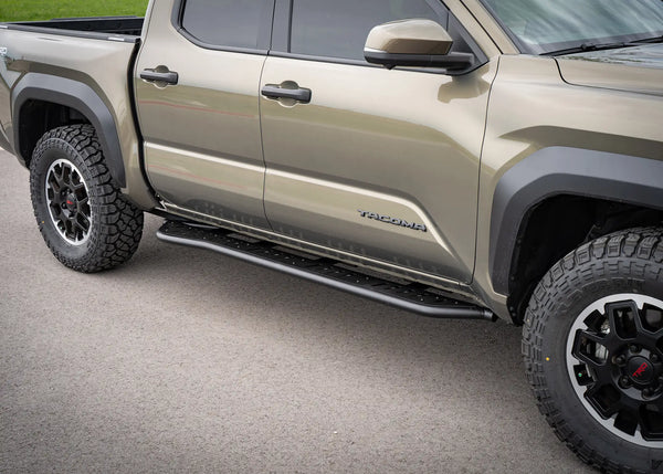 Backwoods Adventure Mods Rock Sliders (2024–2027 Tacoma) — Feature shot: slider installed along the side of a 4th gen Tacoma