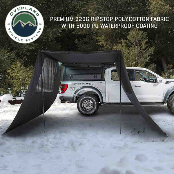 OVS XD Nomadic 90 Awning Wall Kit — Lifestyle shot: blackout side walls on a 90 awning at a forest camp. Private shade for one-vehicle camps