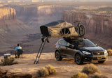 Roofnest Meadowlark — Lifestyle shot: camper sitting beside an open tent on a Crosstrek above a red-rock canyon. Quick escapes on a small car.