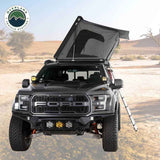OVS HD Sidewinder — Lifestyle shot: tent open on a Ford Raptor at a desert camp, a fast-deploying setup for two