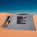 OVS HD Nomadic 180 Awning Wall — Lifestyle shot: 180 awning and side wall set up beside a rig in desert dunes. Wind and sun block for open-country camps