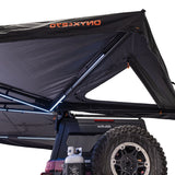 23ZERO Onyx 270 Freestanding Vehicle Awning (Left) — Feature shot: truss arm and logo detail with the rear rooftop-tent pass-through visible