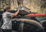 Backwoods Adventure Mods DRIFTR Roof Rack (2005–2023 Tacoma) — Lifestyle shot: strapping storage boxes to the rack
