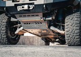 Backwoods Adventure Mods Aluminum Skid Plate System (2005–2023 Tacoma) — Lifestyle shot: raw aluminum skids installed on an overland Tacoma