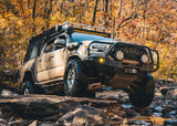 Backwoods Adventure Mods Hi-Lite Bull Bar (2016–2023 Tacoma) — Lifestyle shot: bull bar bumper working on a rocky off-road climb