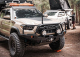 Backwoods Adventure Mods Hi-Lite Bull Bar (2016–2023 Tacoma) — Lifestyle shot: overland Tacoma at camp with the high-clearance bumper