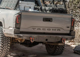 Backwoods Adventure Mods Hi-Lite Rear Bumper (2016–2023 Tacoma) — Lifestyle shot: gray Tacoma with the rear bumper on a dirt trail