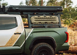 Backwoods Adventure Mods DRIFTR Bed Rack Topper (2007–2027 Tundra) — Feature shot: side view with off-road gear on the rails