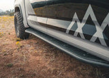 Backwoods Adventure Mods Rock Sliders (2022–2025 Tundra) — Feature shot: slider and aluminum top plate along the cab