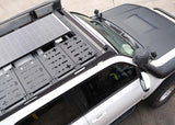 Backwoods Adventure Mods DRIFTR Roof Rack (2010–2024 4Runner) — Feature shot: top of the rack with accessories and a solar panel