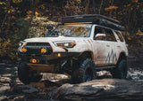 Backwoods Adventure Mods Hi-Lite No Bull Bar (2010–2024 4Runner) — Lifestyle shot: driver on a rough trail with the bumper fitted