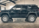Backwoods Adventure Mods Rock Sliders (2010–2024 4Runner) — Lifestyle shot: black 5th gen 4Runner with the sliders installed