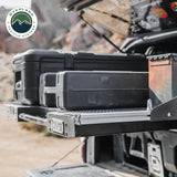 OVS Truck Bed Extension Cargo Slide – Short Bed — Lifestyle shot: bed slide extended from a pickup at camp; cargo pulled out to the tailgate for easy loading at camp or the job site.