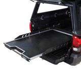 OVS Truck Bed Extension Cargo Slide – Short Bed — Lifestyle shot: three-quarter view installed in a truck bed; cargo pulled out to the tailgate for easy loading at camp or the job site.