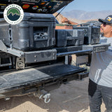 OVS Truck Bed Extension Cargo Slide – Short Bed — Lifestyle shot: bed slide extended from a pickup at camp; cargo pulled out to the tailgate for easy loading at camp or the job site.