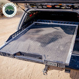 OVS Truck Bed Extension Cargo Slide – Short Bed — Lifestyle shot: bed slide extended from a pickup at camp; cargo pulled out to the tailgate for easy loading at camp or the job site.