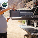 OVS Truck Bed Extension Cargo Slide – Short Bed — Lifestyle shot: bed slide extended from a pickup at camp; cargo pulled out to the tailgate for easy loading at camp or the job site.