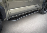 Backwoods Adventure Mods Rock Sliders (2024–2027 Tacoma) — Feature shot: low front-quarter view of the slider and step