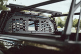 HeadBANGER — Lifestyle shot: viewed from inside the cab, guard mounted behind the rear window under the ACS FORGED crossbars on a parked truck.