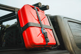 ACS FORGED 20L Jerry Can Holder — Lifestyle shot: red Wavian fuel can locked to the bed rack beside the cab, always within reach on the trail.