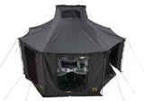 Roofnest Falcon 3 EVO Air Awnex — Lifestyle shot: complete Awnex set up beneath a Falcon 3 EVO Air, giving a covered room off the side of the vehicle at camp