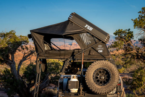 FSR Kali — Lifestyle shot: deployed on a Toyota Tacoma bed rack at a desert campsite