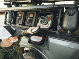 GearBAG G2 3-Pack — Lifestyle shot: a driver lifts the removable mesh pouch from a GearBAG installed next to a jerry can in the GearPOD XL.