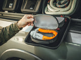 GearBAG G2 3-Pack — Lifestyle shot: close-up of a hand opening the GearBAG's mesh interior pouch to reveal a soft shackle stored inside.