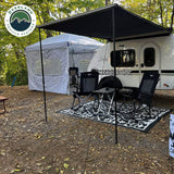 OVS HD Nomadic 90 Awning — Lifestyle shot: shading a teardrop trailer camp with chairs set up underneath. Simple, quick shade for weekend trailer trips