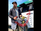 HydroPOD ACS RACK Shower Kit — Lifestyle shot: an angler rinses sand from a fly reel using the hose from the truck's rack-mounted tank after a day on the water.
