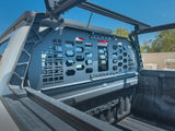 HeadBANGER — Lifestyle shot: guard installed in a light-colored work truck's bed, photographed on a jobsite with building materials nearby.