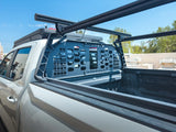 HeadBANGER — Lifestyle shot: side angle of a work truck bed showing the guard mounted beneath the rack rails at a construction site.