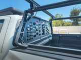 HeadBANGER — Lifestyle shot: side/rear quarter view of a light-colored truck bed with the guard installed, construction materials visible in the background.
