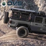 OVS Ruff Rax Bed Rack – 2018–2027 Jeep Gladiator 5 ft — Lifestyle shot: rack installed on the truck; rooftop tent, awning and recovery gear carried above the bed for multi-day trips.