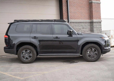 Backwoods Adventure Mods DRIFTR Roof Rack (2024–2027 GX550) — Lifestyle shot: black GX550 with the rack, ready for a trip