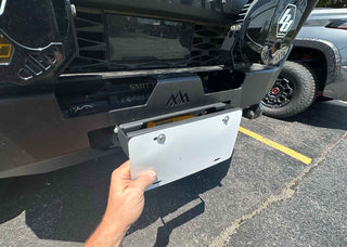 Backwoods Adventure Mods Flip-Up License Plate Holder (Hawse Fairlead) — Feature shot: flip-up plate holder mounted on a Hi-Lite bumper over a hawse fairlead