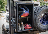 Backwoods Adventure Mods Overland Storage Box (Universal) — Lifestyle shot: box open on a rear swing-out bumper showing the shelf and cargo