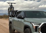 Backwoods Adventure Mods Bike Tray Mounts (Universal) — Lifestyle shot: green Toyota Tundra hauling a mountain bike on the bed rack