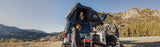 Roofnest Condor 2 XXL Air — Lifestyle shot: open tent on a Jeep at a high desert camp with mountains behind, room for the whole crew