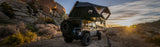 Roofnest Condor 2 XXL Air — Lifestyle shot: open tent on a Jeep among granite boulders at sunset, ready for a family weekend