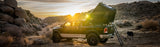 Roofnest Falcon 3 EVO XL Air — Lifestyle shot: open clamshell on a pickup in rocky desert at sunset, a low-profile setup for road trips