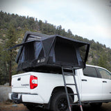 OVS XD Everest cantilever rooftop tent open on a white pickup with the ladder down