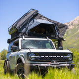 OVS XD Atlas rooftop tent open on a Bronco with mountains behind