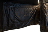 FSR 270 Awning Walls V2 — Lifestyle shot: enclosed awning room at night lit by the awning's LED strips, a sheltered space to cook and hang out after dark