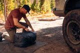 FSR 270 Awning Walls V2 — Lifestyle shot: unpacking the walls from their storage bag at a forest campsite before a weekend trip
