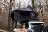 FSR Kali King — Lifestyle shot: Kali King deployed on a Toyota 4Runner at a wooded campsite, a 72-inch-wide fold-out that sleeps a family of four
