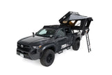FSR Kali — Feature shot: front angle with lights on and windows open, mounted on a 4th-gen Tacoma