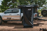 FSR Shower Awning Kit — Lifestyle shot: installed on a Toyota Tacoma overlanding setup in a wooded campsite