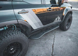 Backwoods Adventure Mods Rock Sliders (2024–2027 Land Cruiser 250) — Lifestyle shot: black Land Cruiser 250 with the sliders installed